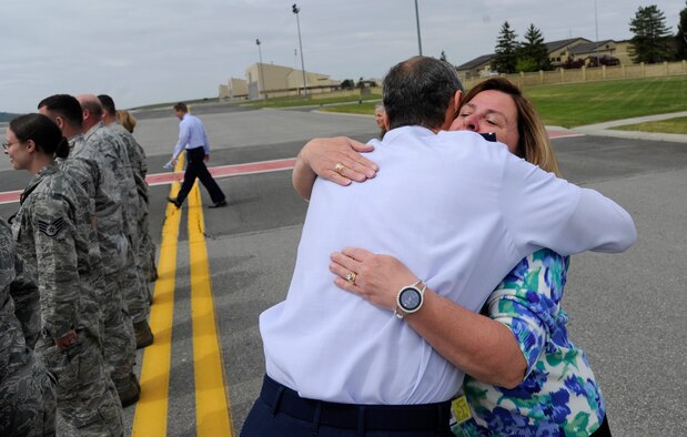 Gen. Raymond Johns, Jr., Air Mobility Command commander, hugs Bo Smith-Tallan, 92nd Air Refueling Wing protocol chief, as he departs Fairchild Air Force Base, Wash., during a recent visit May 20, 2012. If something needs to be done, whether it’s picking up trash, pitching luggage or washing vehicles and someone else hasn't done their job, then the wing’s protocol office is there getting the mission done. (U.S. Air Force photo/Airman 1st Class Ryan Zeski)