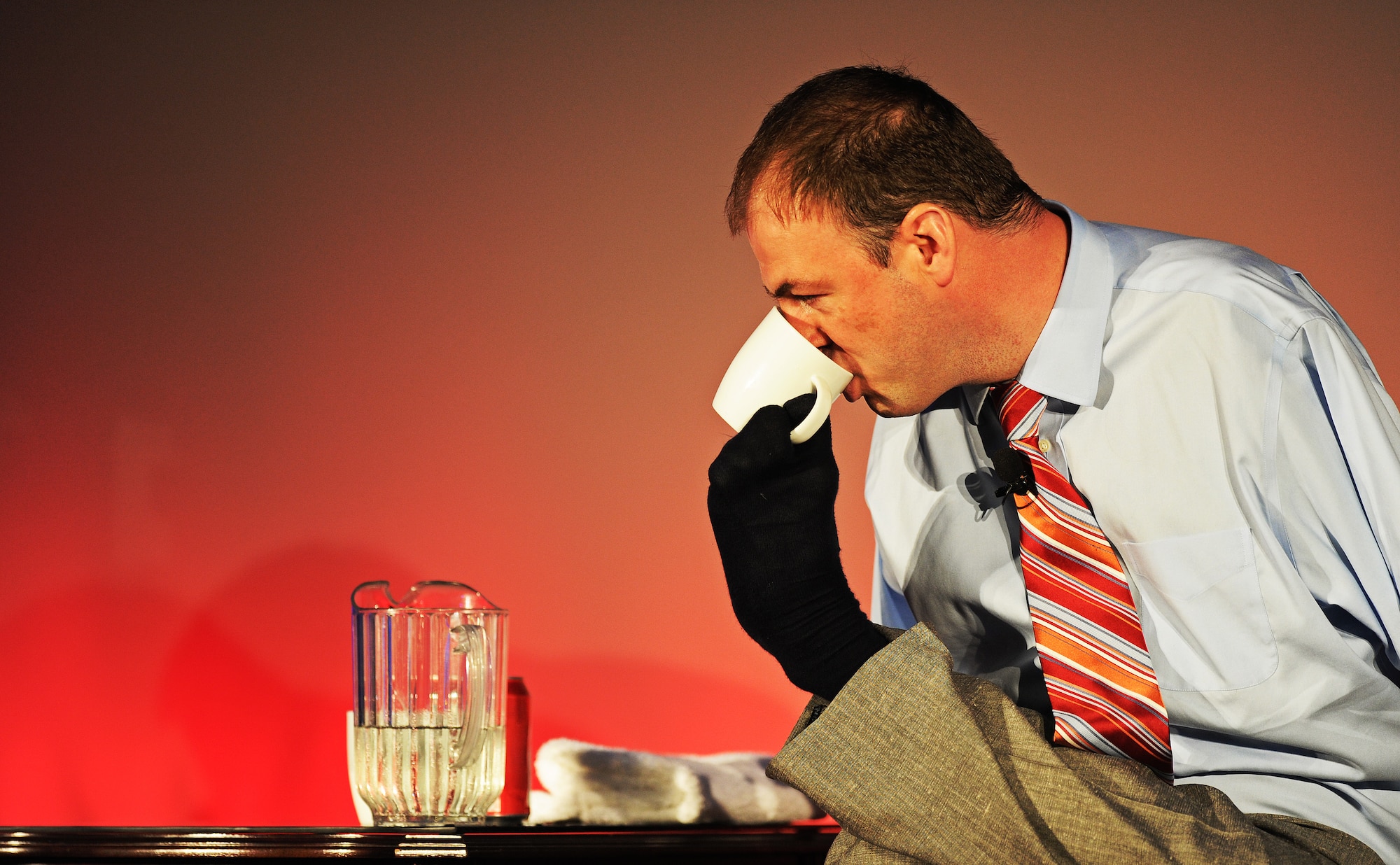 John Foppe, motivational speaker who was born without arms, demonstrates how he has overcome day-to day tasks during a TEDx talk at Scott Air Force Base, Ill. May 30.  He learned that the inability to do something didn’t rest on the lack of resources or vision. Instead, it has more to do with one’s subconscious perception to meeting a challenge head on. (U.S. Air Force photo/ Staff Sgt. Ryan Crane)