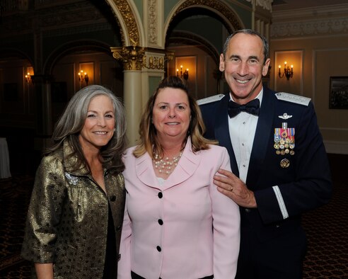 Gen. Raymond Johns, Jr., Air Mobility Command commander, and his wife, Diana, pose for a photo with Bo Smith-Tallan, 92nd Air Refueling Wing protocol chief, during the couple’s recent visit to Fairchild Air Force Base, Wash., May 18, 2012. If something needs to be done, whether it’s picking up trash, pitching luggage or washing vehicles and someone else hasn't done their job, then the wing’s protocol office is there getting the mission done. (U.S. Air Force photo/Airman 1st Class Ryan Zeski)