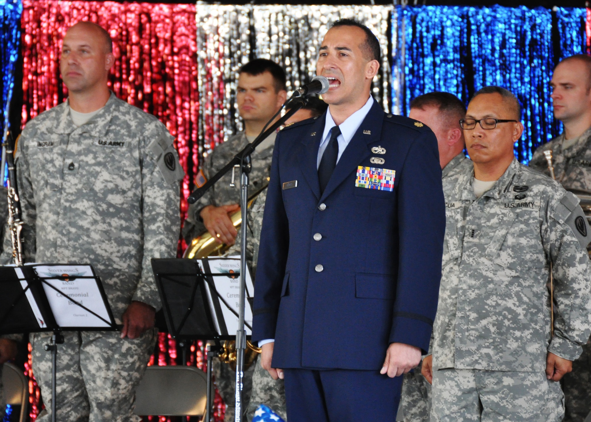 Maj. Edward Torres, 919th Aircraft Maintenance Squadron, sings the National Anthem during the opening of the Military Appreciation Recognition Celebration event May 19 in Crestview, Fla.  Torres was among a group of Duke Field reservists that joined their sister service units at the non-profit MARC organization's annual Armed Forces Day salute to the area's military men and women.  Shown behind him are bandsmen from the 98th Army Band's Silver Wings ceremonial band from Fort Rucker, Ala. (Courtesy photo)