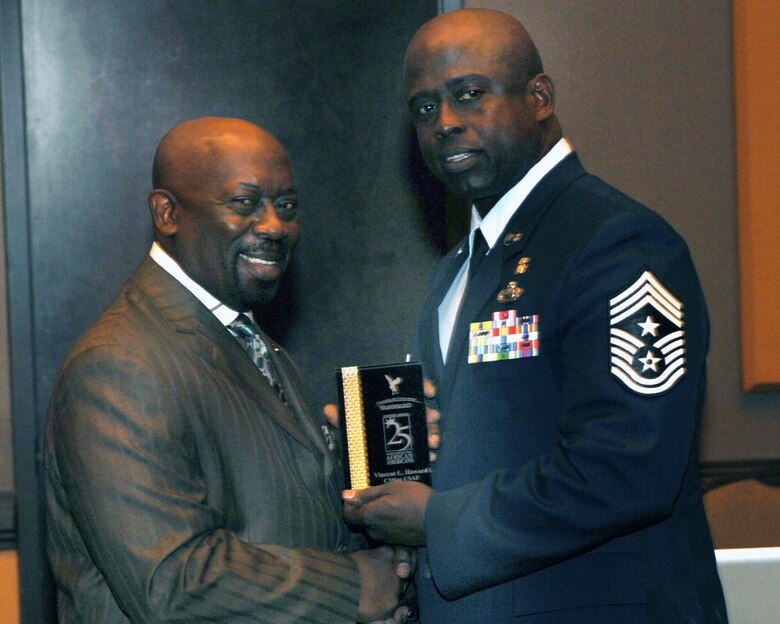 U.S. Air Force Chief Master Sgt. Vincent Howard, 355th Fighter Wing command chief, left, receives the award for one of the 25 Most Influential African Americans of Southern Arizona from Clarence Boykins, Vanguard/Tucson –Southern Arizona Black Chamber of Commerce, in a luncheon in Tucson May 26. (U.S. Air Force photo by Tech Sgt. Russell Martin/Released)