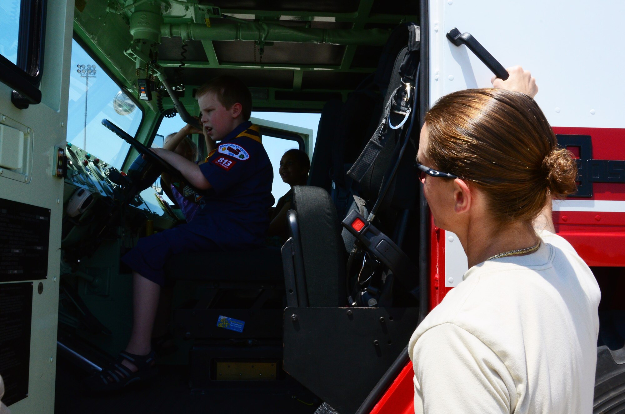 WRIGHT-PATTERSON AIR FORCE BASE, Ohio - Senior Airman Jennifer Godsey, 445th Civil Engineer Squadron firefighter, lets Scouts tour a fire truck during the 445th Airlift Wing Scouts Day May 19. (U.S. Air Force photo/Staff Sgt. Amanda Duncan)