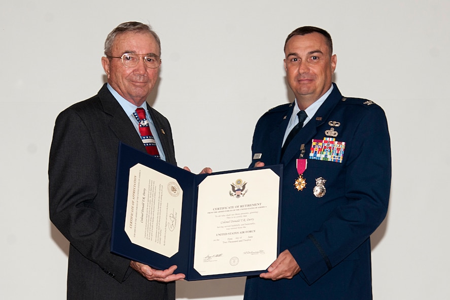 U.S. Air Force Col. Donald Derry, Pacific Air Forces Security Forces Division chief, Joint Base Pearl Harbor-Hickam, Hawaii, receives his retirement certificate from retired Brig. Gen. Richard Coleman, at Moody Air Force Base, Ga., May 29, 2012. Coleman reflected on Derry’s career and how he was one of the founding members of the 820th Security Forces Group when it was created in 1997. (U.S. Air Force Photo by Airmen 1st Class Paul Francis/Released)