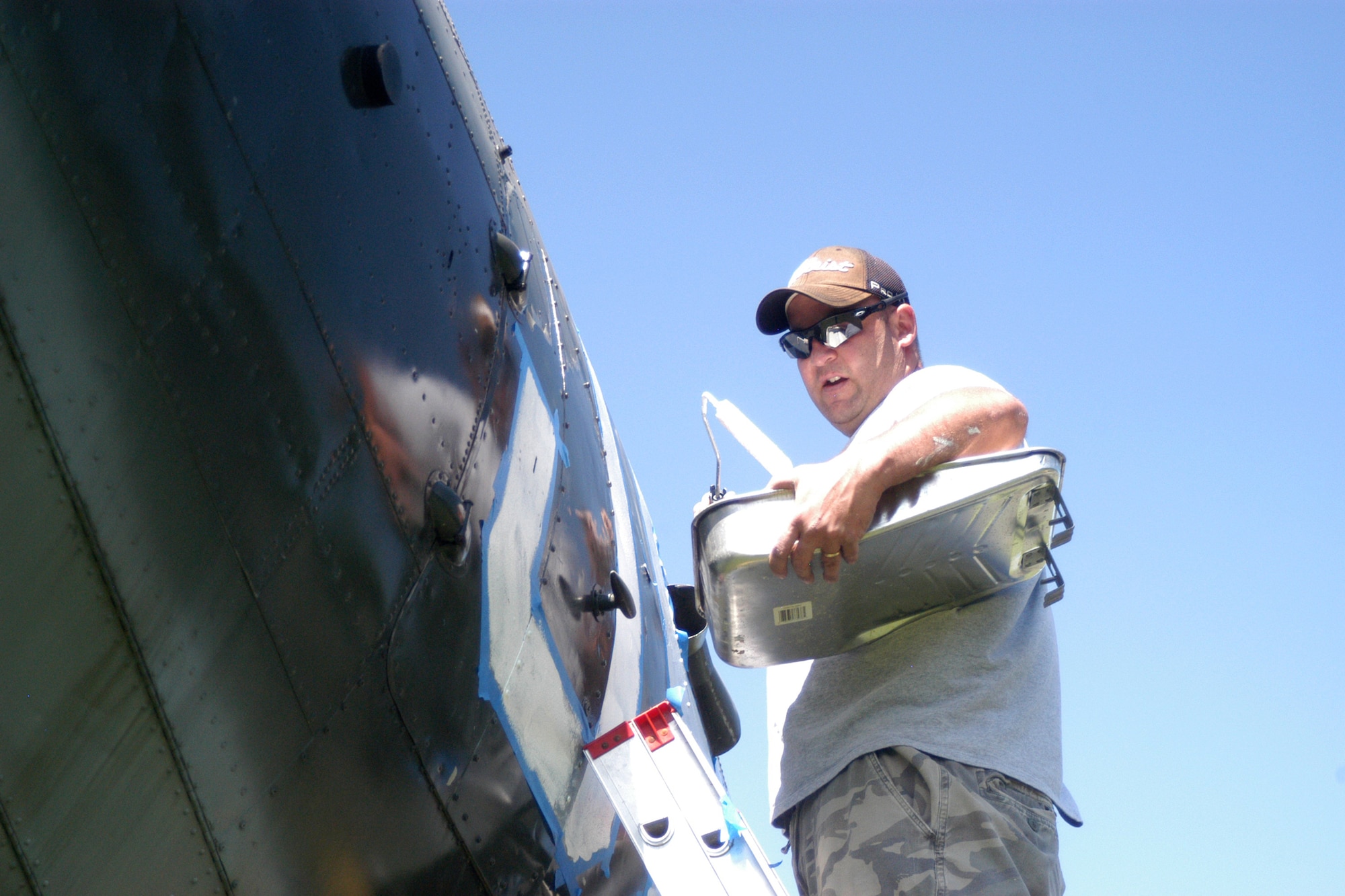 Air Force Master Sgt. Scott McCoy, 19th Air Support Operations Squadron first sergeant, paints historical markings on the C-47 with tail number 42-100828. The C-47, currently on display at Fort Campbell, Ky., is a significant part of the 101st Airborne Division's World War II history. The plane was involved in every major airborne and glider-borne assault in the European Theater of operations, to include Operations DRAGOON, MARKET-GARDEN and VARSITY. The aircraft also dropped paratroopers from the 506th Parachute Infantry Regiment, now known as the 4th Brigade Combat Team, "Currahees," into Drop Zone "C" at J+30, roughly 1:15 a.m. June 6, 1944.  The restoration will take approximately 10 days with a total of 500 hours to restore the aircraft’s exterior. (U.S. Army photo by Nondice Thurman)