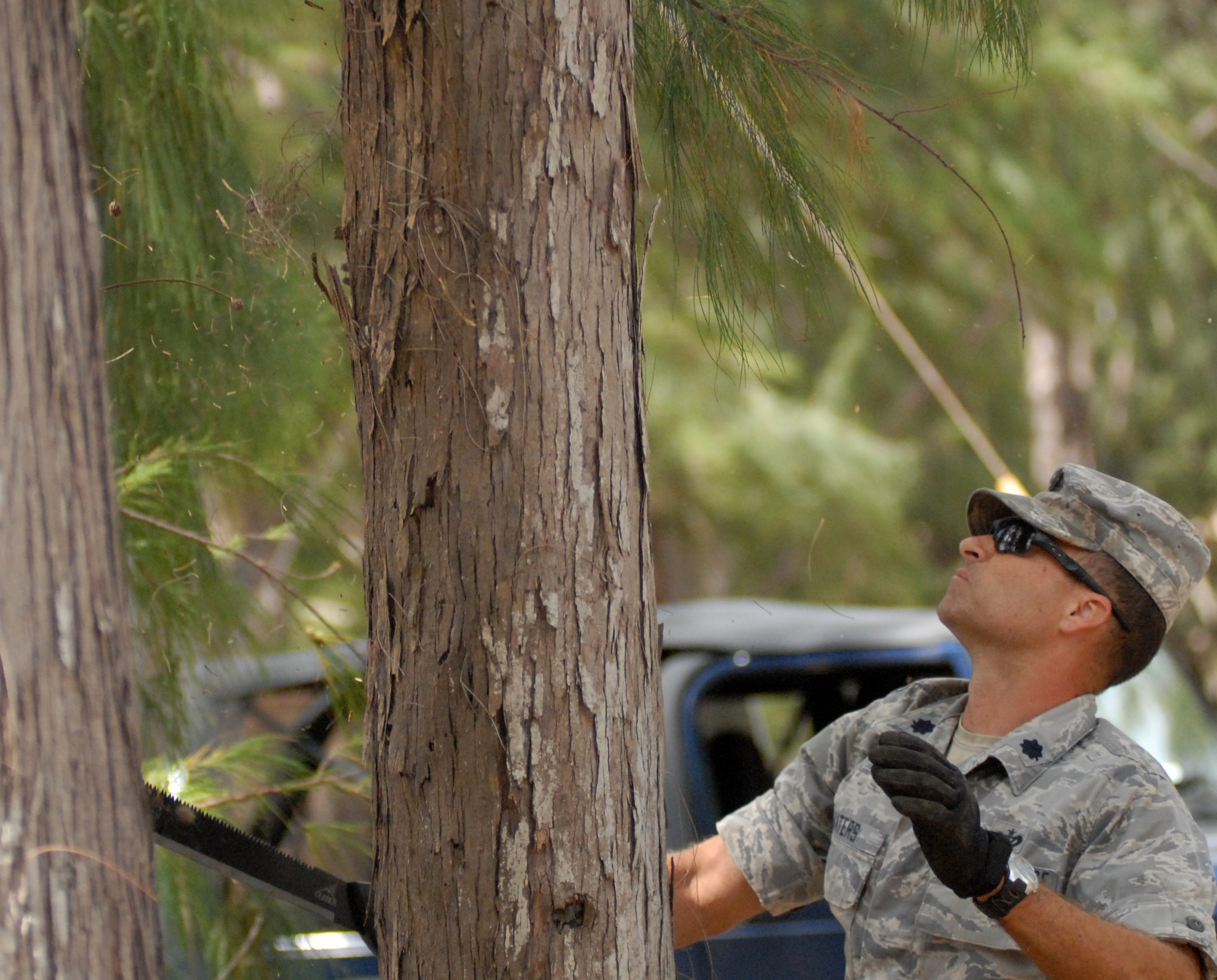 Lt. Col. Bradley Waters, 647th Civil Engineer Squadron commander at Joint Base Pearl Harbor-Hickam, Hawaii, trims trees with a machete at Bellows Air Force Station May 23 as part of the squadron's Prime BEEF exercise. Prime Base Engineer Emergency Force (BEEF) teams are rapidly deployable, specialized civil engineer units, that provide a full range of engineering support required to establish, operate, and maintain garrison and contingency airbases. (U.S. Air Force photo by 2nd Lt. Jessica Rowe)