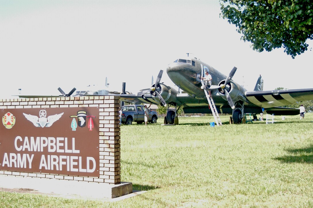 Volunteers from the 19th Air Support Operations Squadron work on some of the detail painting involved in restoring a C-47 at Fort Campbell, Ky. The C-47, tail number 42-100828, is a significant part of the 101st Airborne Division's World War II history. The plane was involved in every major airborne and glider-borne assault in the European Theater of operations, to include Operations DRAGOON, MARKET-GARDEN and VARSITY. The aircraft also dropped paratroopers from the 506th Parachute Infantry Regiment, now known as the 4th Brigade Combat Team, "Currahees," into Drop Zone "C" at J+30, roughly 1:15 a.m. June 6, 1944.  (U.S. Army photo by Nondice Thurman)