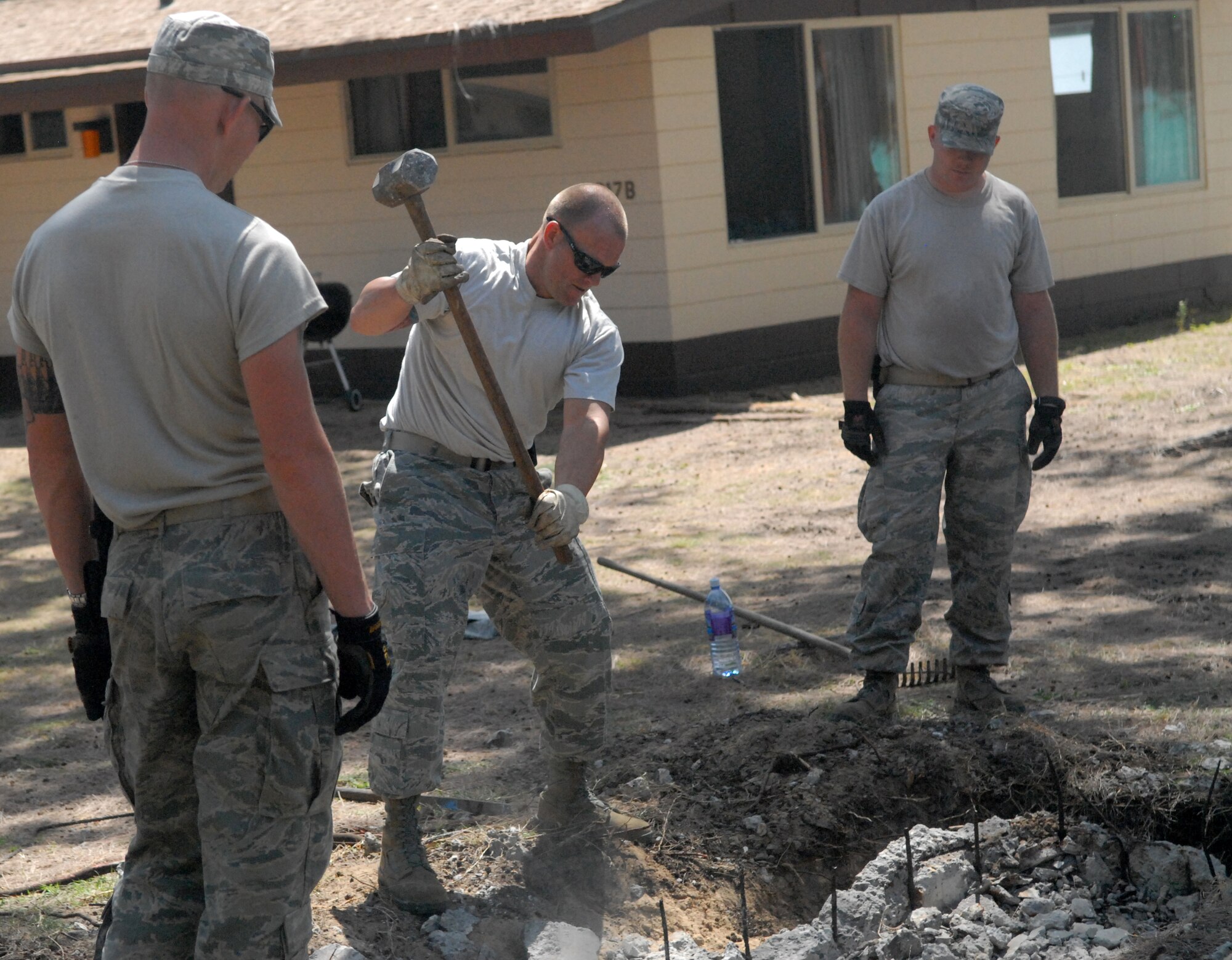 Master Sgt. Jason Wondoloski from the 647th Civil Engineer Squadron at Joint Base Pearl Harbor-Hickam, Hawaii, breaks up an old, non-active cement fixture and pipe at Bellows Air Force Station May 23 as part of the squadron's Prime BEEF exercise. Prime Base Engineer Emergency Force (BEEF) teams are rapidly deployable, specialized civil engineer units, that provide a full range of engineering support required to establish, operate, and maintain garrison and contingency airbases. (U.S. Air Force photo by 2nd Lt. Jessica Rowe)