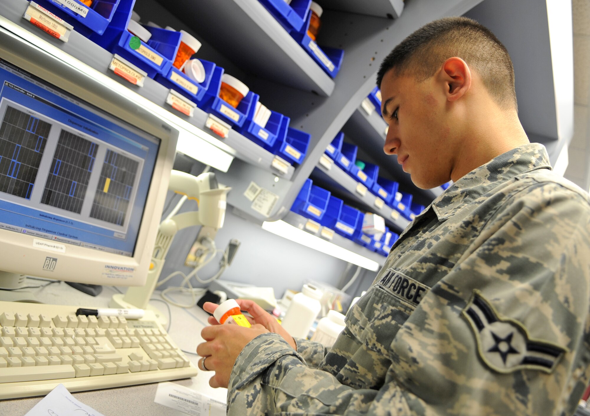 U.S. Air Force Airman 1st Class Derrik Reust inspects a labeled prescription bottle at the pharmacy on Seymour Johnson Air Force Base, N.C., May 30, 2012. Pharmacy technicians must ensure patients receive the proper medication as well as the correct dosage prior to release. Reust, 4th Medical Support Squadron pharmacy technician, hails from Bay Village, Ohio. (U.S. Air Force photo/Airman 1st Class Aubrey Robinson/Released)