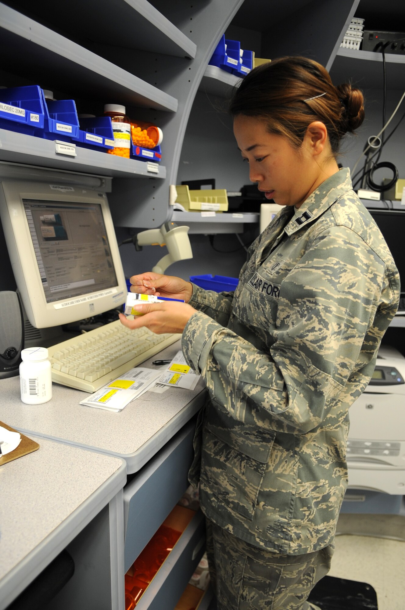 U.S. Air Force Capt. Crystal Cha applies a label to a prescription bottle on Seymour Johnson Air Force Base, N.C., May 30, 2012. Proper labeling ensures the prescribed medication goes to the correct patient. Cha, 4th Medical Support Squadron pharmacist, hails from Hickory, N.C. (U.S. Air Force photo/Airman 1st Class Aubrey Robinson/Released)
