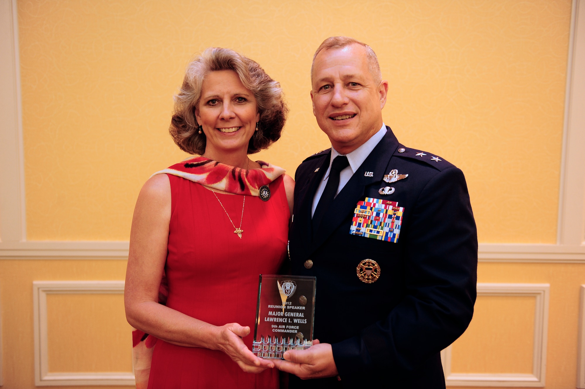 Maj. Gen. Larry Wells, 9th Air Force commander, and his wife Kathy Wells pose together holding an appreciation award presented during the memorial banquet ceremony at the Marriot Hotel in Columbia, S.C., May 25, 2012. The farewell banquet was the last event in a three day tour of events at Shaw AFB, Sumter and the surrounding communities. (U.S. Air Force photo by Airman Daniel B. Blackwell/Released)
