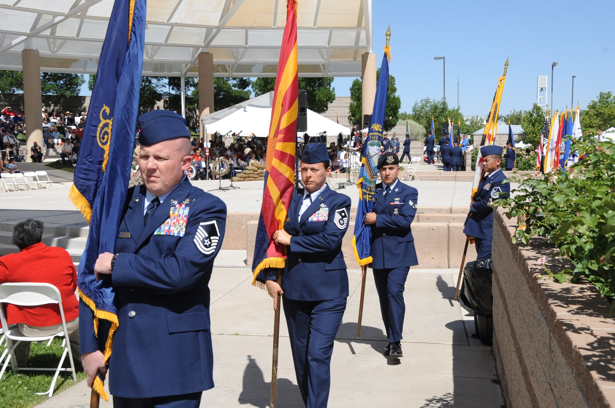 KIRTLAND AFB, N.M. -- Volunteers from Kirtland Air Force Base carry the 50 state flags during a Memorial Day ceremony Monday at the New Mexico Veterans Memorial. More than 500 people attended, including leadership from across the base. The event featured Congressman Martin Heinrich and Albuquerque Mayor Richard Berry as keynote speakers. (Photo by Dennis Carlson) 