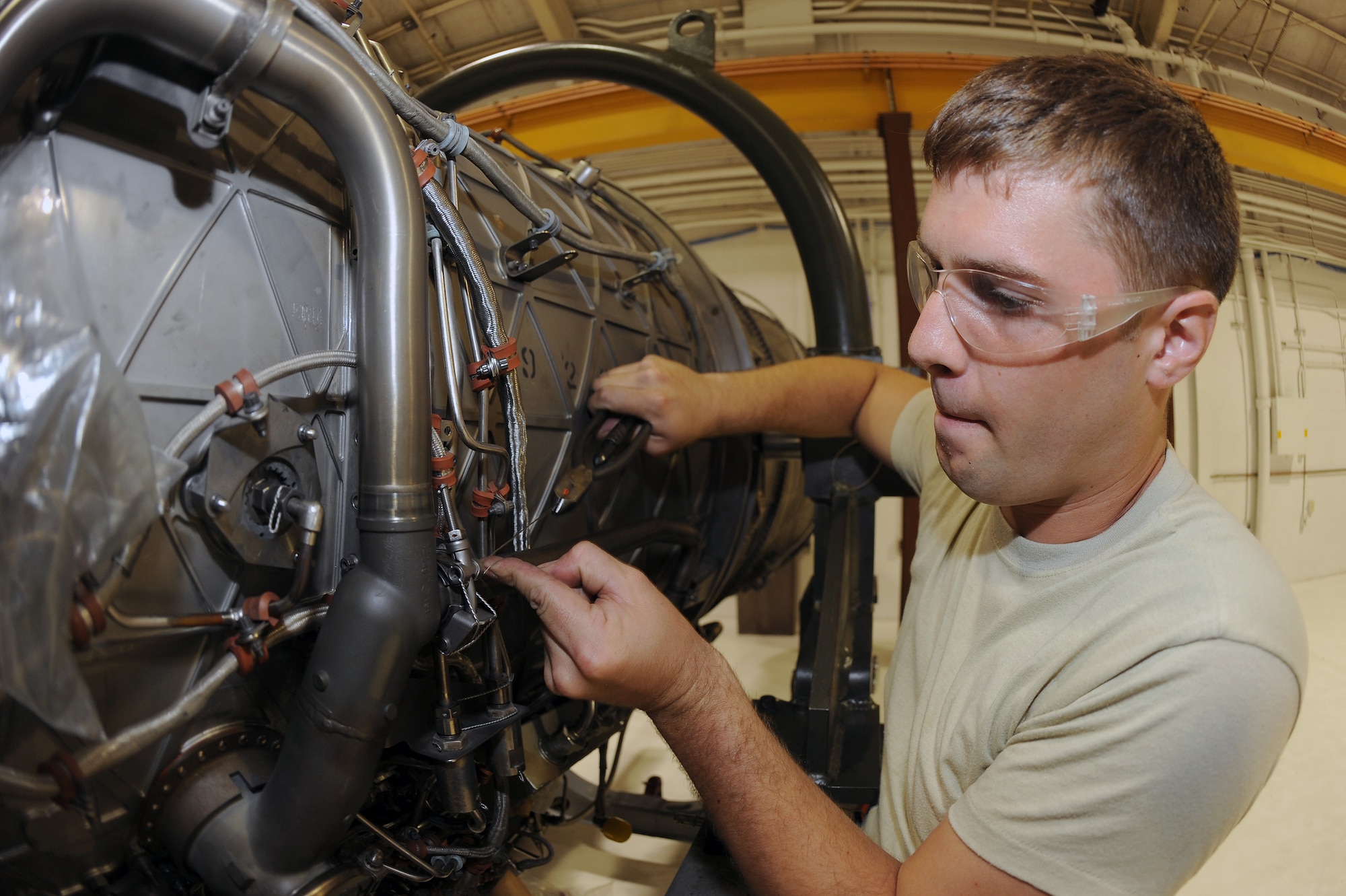 U.S. Air Force Airman 1st Class Joshua Tutolo places a safety wire into a v-band clamp of an F-15E Strike Eagle’s engine on Seymour Johnson Air Force Base, N.C., May 29, 2012. The v-band clamp fastens equipment in pumps, engines and exhaust systems while the safety wire ensures the v-band stays secure. Tutolo, 4th Component Maintenance Squadron aerospace propulsion journeyman, is from Chardon, Ohio. (U.S. Air Force photo/Airman 1st Class John Nieves Camacho/Released)