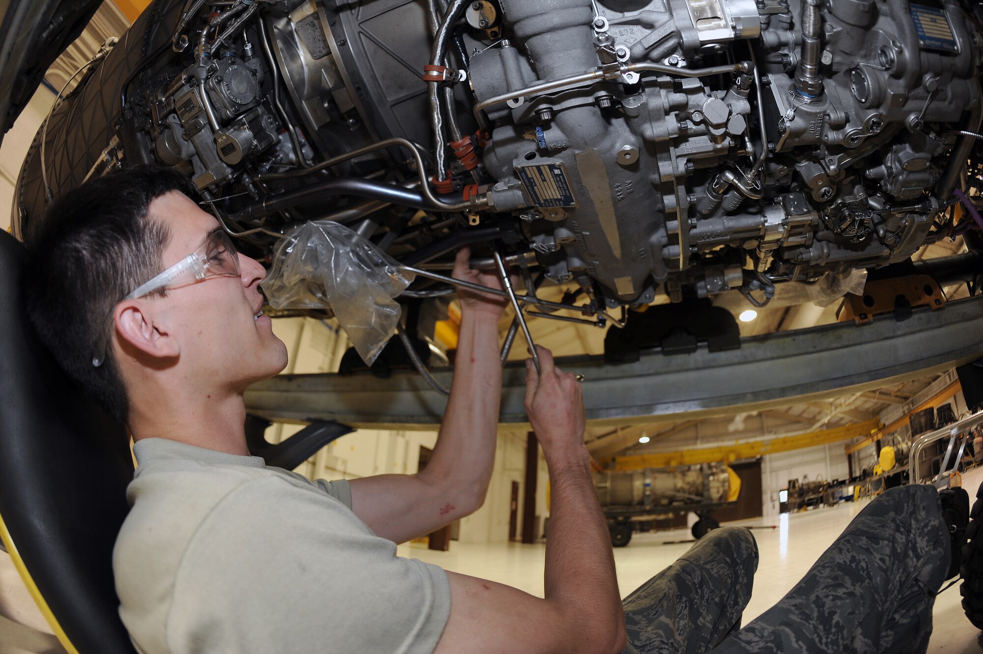 U.S. Air Force Senior Airman Nathanael Rehburg routes cables on an F-15E Strike Eagle engine on Seymour Johnson Air Force Base, N.C., May 29, 2012. Routing cables with adequate spacing prevents chaffing and wear, which avoids malfunctions. Rehburg, 4th Component Maintenance Squadron aerospace propulsion apprentice, hails from San Angelo, Texas. (U.S. Air Force photo/Airman 1st Class John Nieves Camacho/Released)