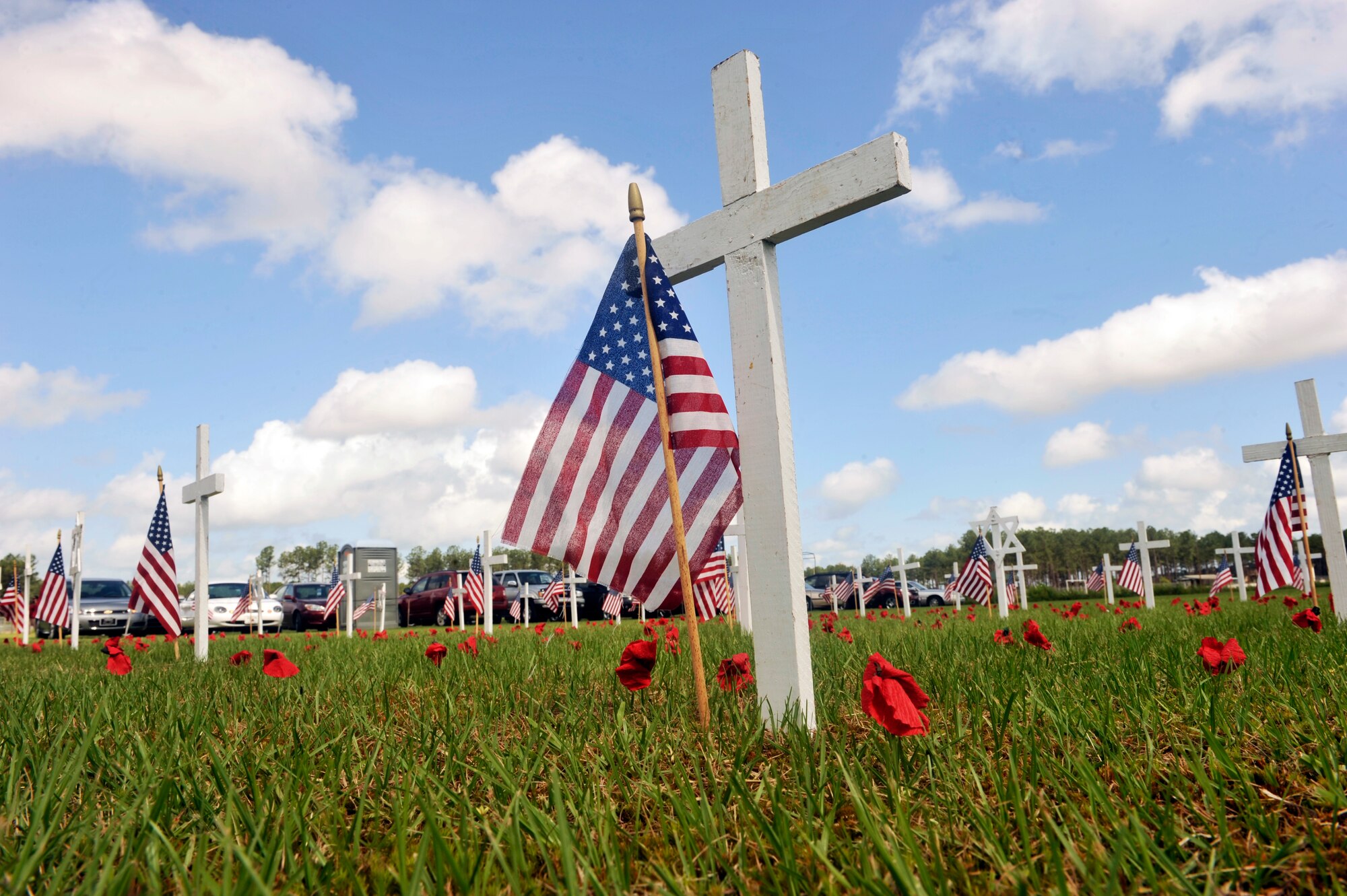 Sumter County Veterans Association placed crosses to honor all of the fallen men and women who served in the United States Armed Forces for the Memorial Day Ceremony at General George Mabry's Memorial in Sumter, S.C., May 28, 2012. The poppy flowers by the crosses and Star of David remind of war ending and the poppys growing again on the grounds on which World War I was fought. (U.S. Air Force photo by Senior Airmen Tabatha McCarthy/released)