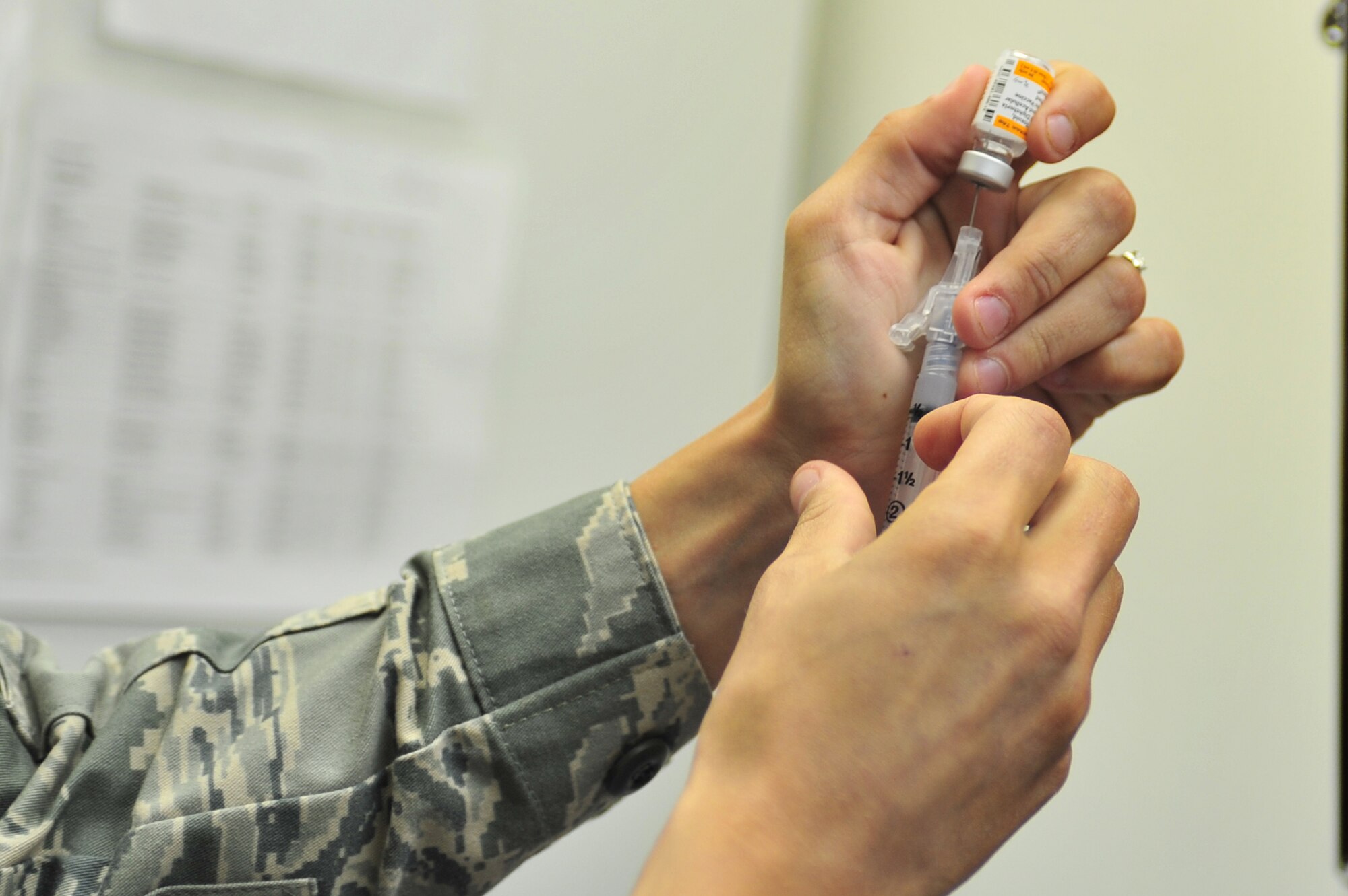 U.S. Air Force Staff Sgt. Dena Levari, 27th Special Operations Medical Operations Squadron NCOIC of immunizations, extracts a prepared Tetanus, Diphtheria, Pertussis vaccination solution with a syringe for a patient in the clinic at Cannon Air Force Base, N.M., May 29, 2012. The Tdap vaccine protects against those viruses that can cause illness like lockjaw and whooping cough. (U.S. Air Force photo by Airman 1st Class Alexxis Pons Abascal)  