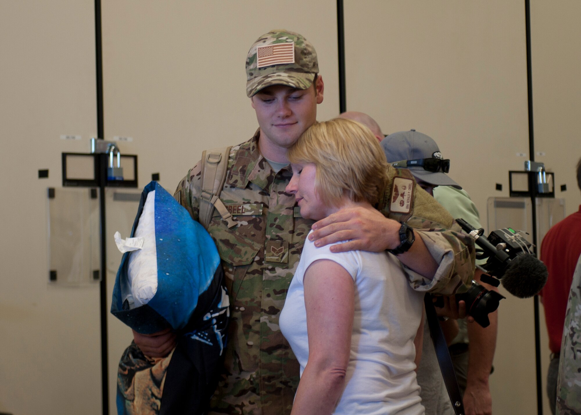 U.S. Air Force Senior Airman Gerald Creel, 38th Rescue Squadron, hugs his mother before leaving for a deployment to Afghanistan at Moody Air Force Base, Ga., May 24, 2012. This is no usual deployment for the 38th RQS and supporting Airmen deploying with them, because crew members from National Geographic will accompany them to document missions for a six-episode series on the PJs. (U.S. Air Force photo by Senior Airman Eileen Meier/Released)  