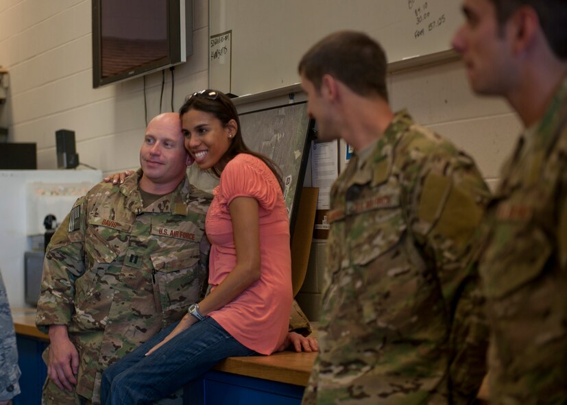 U.S. Air Force Capt. Seth Davis, 38th Rescue Squadron, poses for a photo with a loved one minutes before deploying to Afghanistan from Moody Air Force Base, Ga., May 24, 2012. Airmen with the 38th RQS and other various units will be featured in a six-episode series on pararescuemen, documented by members of National Geographic who will accompany the PJs throughout their deployment. (U.S. Air Force photo by Senior Airman Eileen Meier/Released)