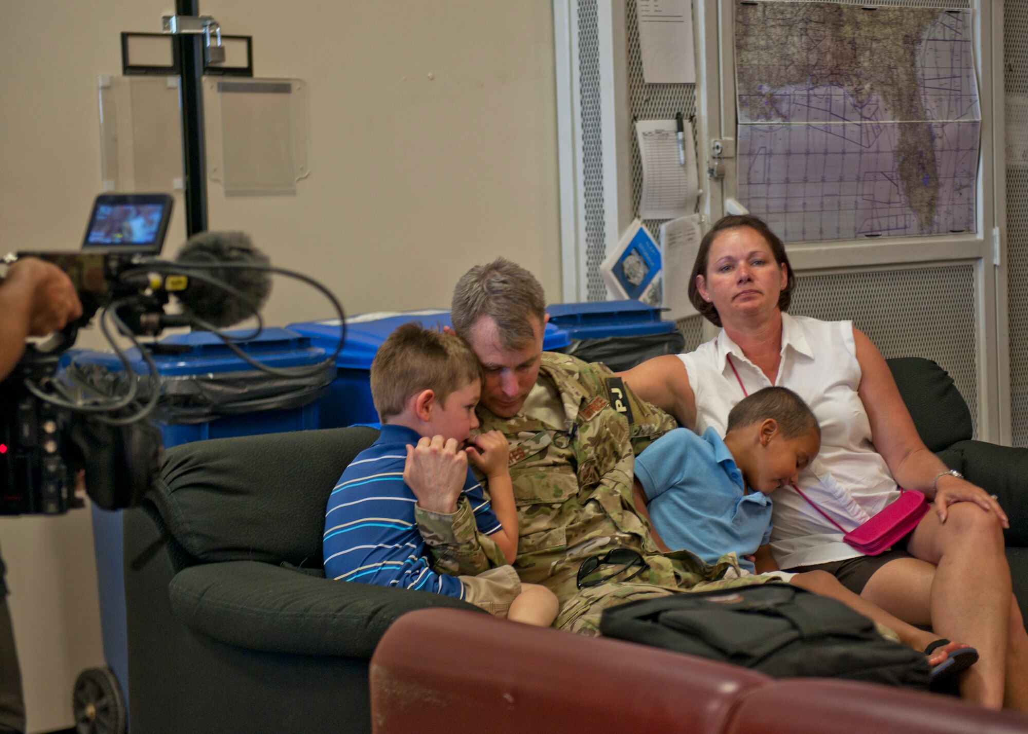 U.S. Air Force Tech. Sgt. Duane Hayes, 38th Rescue Squadron, embraces his family minutes before departing for Afghanistan while a National Geographic crew captures footage for a six-episode series on pararescuemen at Moody Air Force Base, Ga., May 24, 2012. National Geographic will accompany the PJs to capture their journey from the second they leave their families through their time in Afghanistan. (U.S. Air Force photo by Senior Airman Eileen Meier/Released)