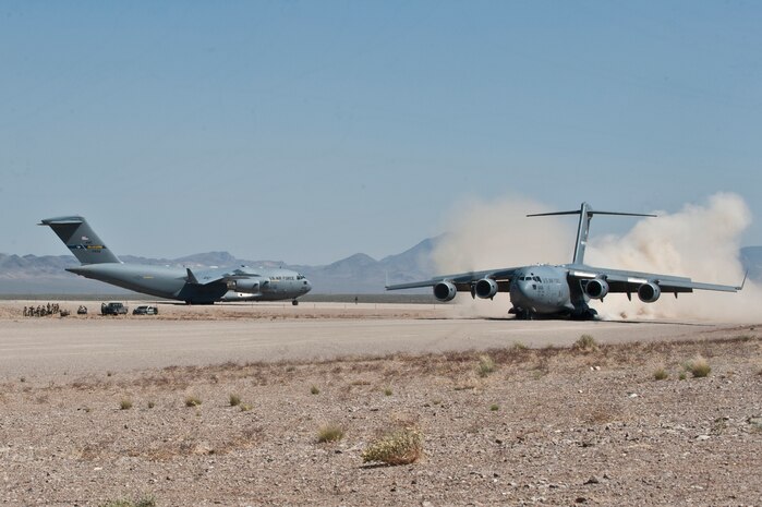 Two U.S. Air Force C-17 Globemaster IIIs prepare to take off from a dirt runway during a Mobility Air Forces Exercise May 23, 2012, at the Nevada Test and Training Range. The aircraft conducted simulated and actual low-altitude drops of airborne forces. (U.S. Air Force photo/Airman 1st Class Jason Couillard)


