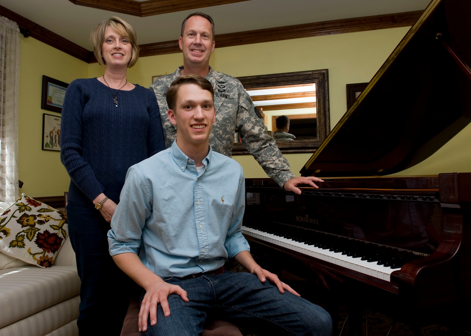 William Hume takes a break from playing piano for a photo with his father, U.S. Army Col. Robert Hume, the Army Capabilities Integration Center Studies and Analysis Division chief, and his mother Laura, at their home in Yorktown, Va., May 21, 2012. William has joined several local musical groups, including Williamsburg's Tidewater Intergenerational Orchestra and Hampton's Liberty Academy of the Arts Orchestra, as a soloist.  (U.S. Air Force photo by Senior Airman John D. Strong II/Released)