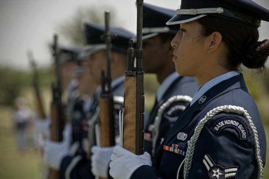 Airman 1st Class Twila Stone, 7th Logistics Readiness Squadron, readies her weapon during a Memorial Day ceremony May 28, 2012, at the Texas State Veteran Cemetery in Abilene, Texas. Memorial Day is a day of remembering the men and women who died while serving in the United States Armed Forces. Formerly known as Decoration Day, it originated after the American Civil War to commemorate the Union soldiers who died in the Civil War. By the 20th century Memorial Day had been extended to honor all Americans who have died in all wars. (U.S. Air Force photo by Airman 1st Class Jonathan Stefanko/ Released)