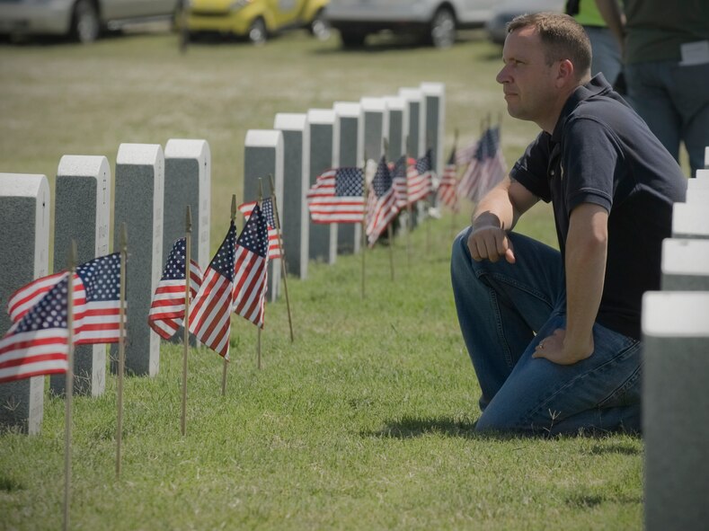 Master Sgt. Charles Hoyt, 7th Component Maintenance Squadron, kneels next to his relatives’ grave during a Memorial Day ceremony May 28, 2012, at the Texas State Veteran Cemetery in Abilene, Texas. Memorial Day is a day of remembering the men and women who died while serving in the United States Armed Forces. Formerly known as Decoration Day, it originated after the American Civil War to commemorate the Union soldiers who died in the Civil War. By the 20th century Memorial Day had been extended to honor all Americans who have died in all wars. (U.S. Air Force photo by Airman 1st Class Jonathan Stefanko/ Released)