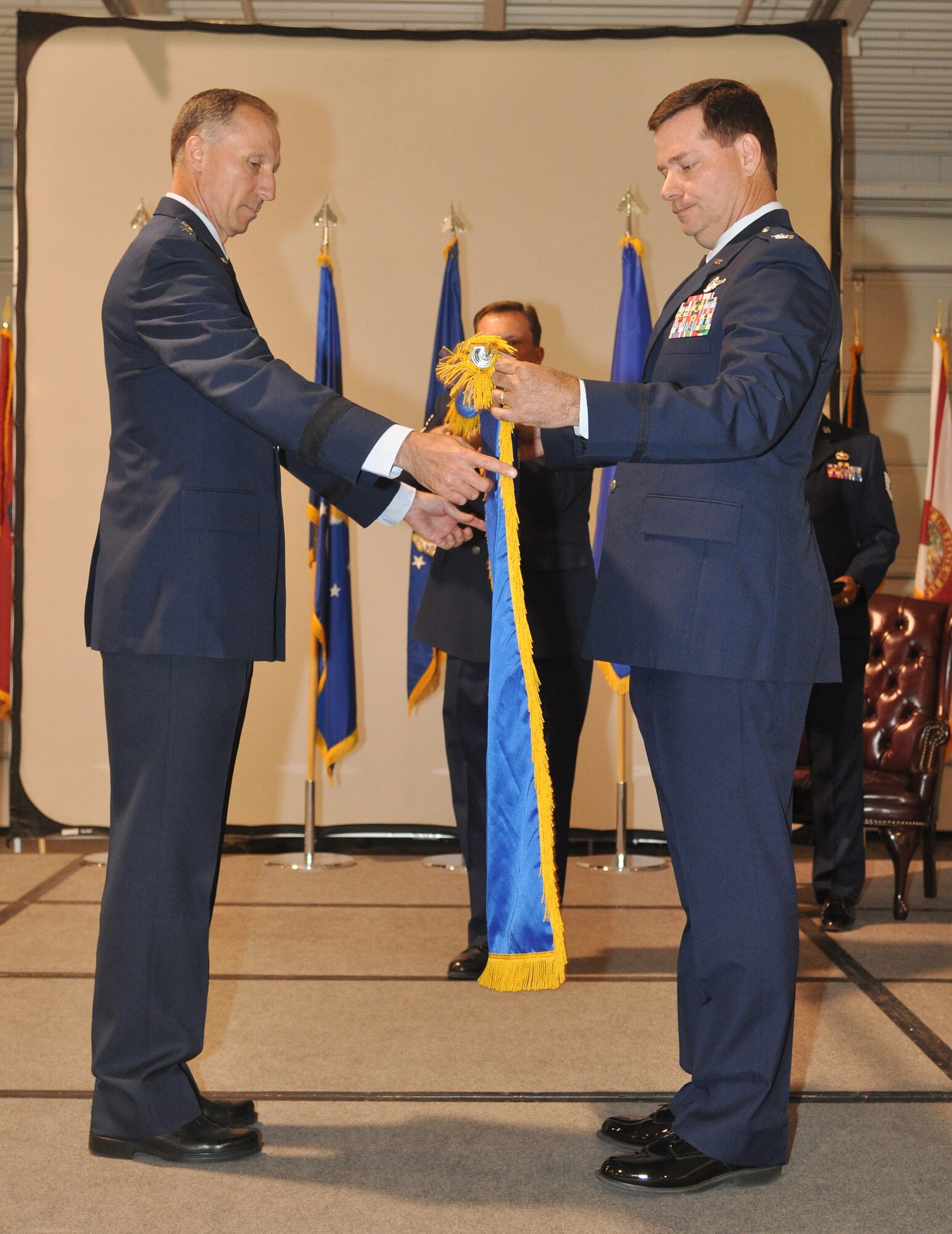 Maj. Gen. William Bender, U.S. Air Force Expeditionary Center commander (l), assists Colonel Gary Gottschall, former 615th Contingency Response Wing commander, furl the flag for the final time during the inactivation ceremony for the 615 CRW, May 29, 2012, at Travis Air Force Base, Calif. The 615 CRW ceased its operations as a sister wing, ending seven years of mobility excellence. The inactivation ceremony also included the transfer of command of the two contingency response groups and one contingency operations group to the 621st Contingency Response Wing, headquartered at Joint Base McGuire-Dix-Lakehurst, N.J. (U.S. Air Force Photo / Master Sgt. Stan Parker)