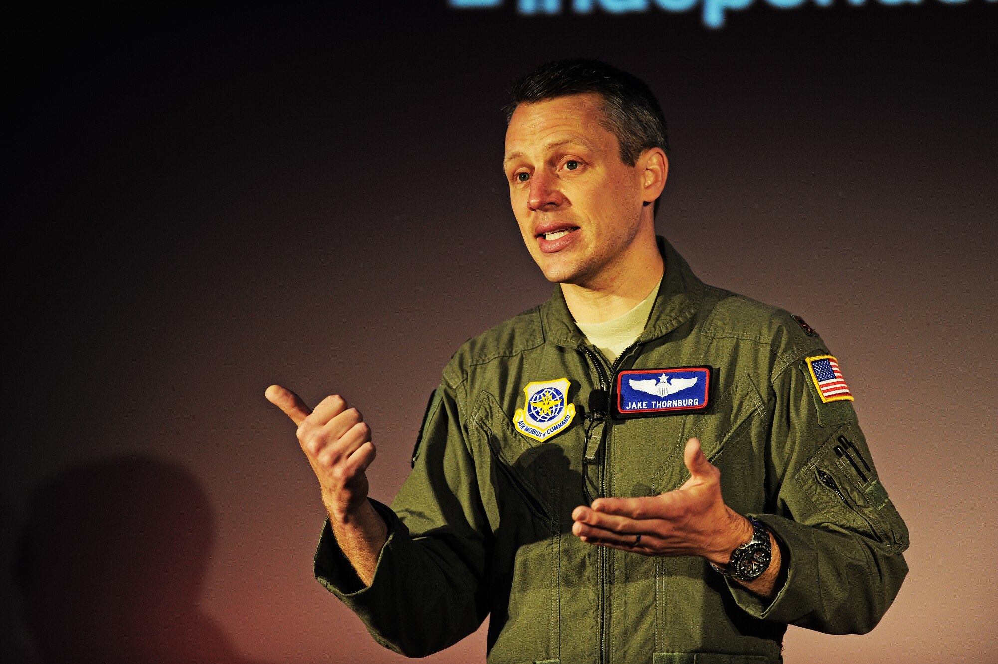 Maj. Jake Thornburg, 62nd Airlift Wing instructor pilot, speaks to the audience during a TEDx talk at Scott Air Force Base, Ill. May 30 about his experience with an honorable return mission where he transported the remains of 19 flag-draped caskets of men who died while serving in Afghanistan.  He maintains expertise in mission preparation, aircraft systems, in-flight refueling, low-altitude and austere airfield operations in the C-17A. (U.S. Air Force photo/ Staff Sgt. Ryan Crane)