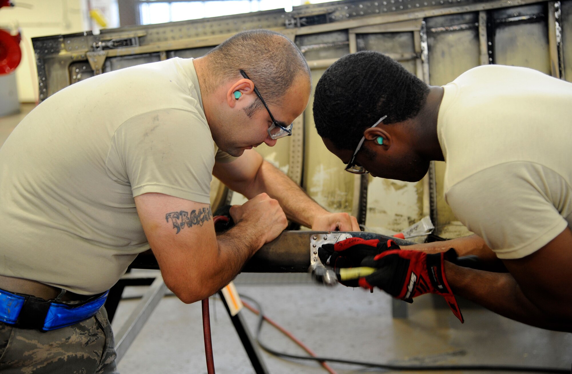 Staff Sgt. Sam Taylor and Airman 1st Class Antonio Robison, 2nd Maintenance Squadron fabrication flight, repair a B-52H Stratofortress engine cowling on Barksdale Air Force Base, La., May 29. The fabrication flight handles the repair of the skin and coverings of the B-52H Stratofortress. (U.S. Air Force photo/Airman 1st Class Andrew Moua)(RELEASED)