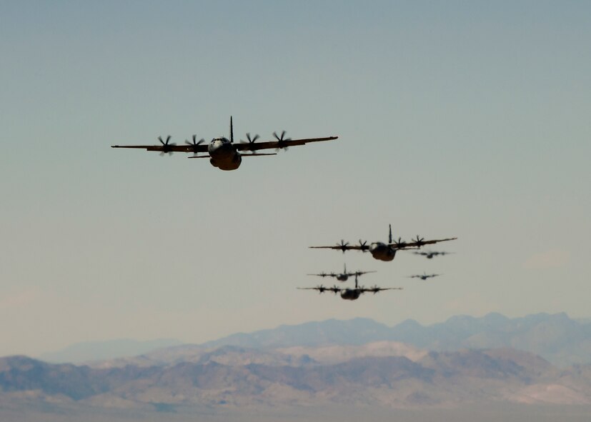 C-130Js from across the Air Force fly over the Nevada Test and Training Range May, 23, 2012 during the U.S. Air Force Weapons School Mobility Forces Exercise. The mass air mobility exercise, in which nearly 70 aircraft primarily consisting of C-17 Globemaster III and C-130 aircraft, practiced a "forced entry" operation. In the scenario, U.S. forces entered a simulated defended enemy country, defeated defending air defense forces and put troops on the ground. (U.S. Air Force photo by Airman 1st Class Damon Kasberg /Released)