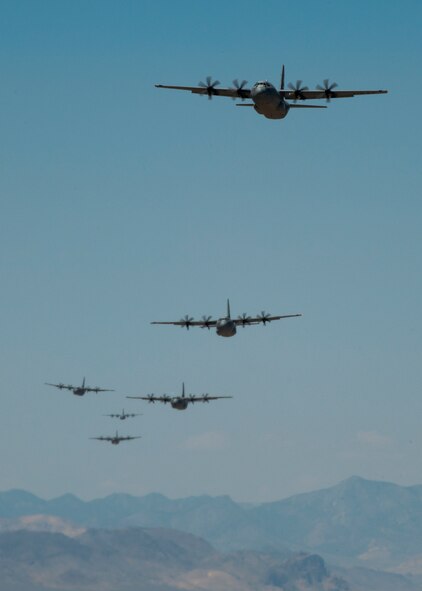 C-130Js from across the Air Force fly over the Nevada Test and Training Range May, 23, 2012 during the U.S. Air Force Weapons School Moblilty Forces Exercise. The mass air mobility exercise, in which nearly 70 aircraft primarily consisting of C-17 Globemaster III and C-130 aircraft, practiced a "forced entry" operation. In the scenario, U.S. forces entered a simulated defended enemy country, defeated defending air defense forces and put troops on the ground. (U.S. Air Force photo by Airman 1st Class Damon Kasberg /Released)