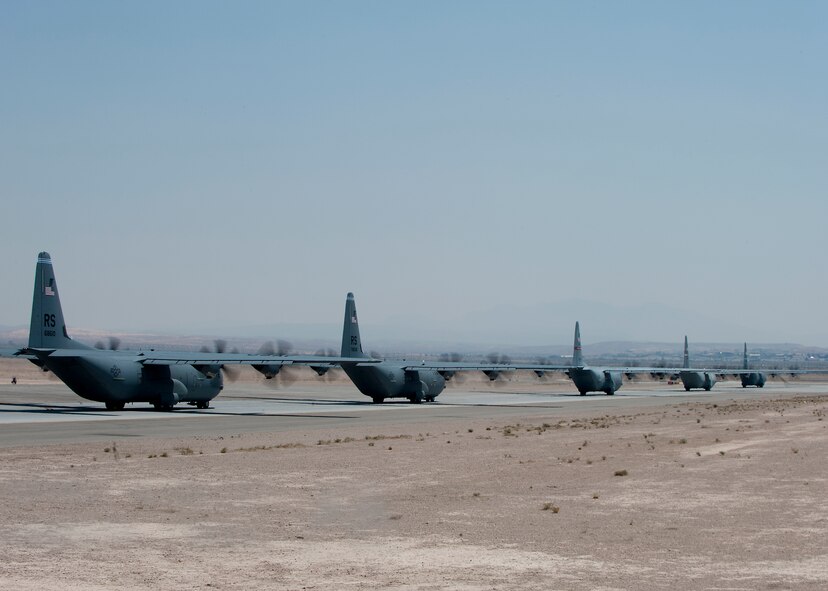 C-130Js from across the U.S. Air Force line the Nellis Air Force Base, Nev., runway May 23, 2012, to support the U.S. Air Force Weapons School’s Mobility Forces Exercise. The exercise is part of a six-month Weapons Instructor Course conducted by the school. After graduation, Air Force Weapons School students become Weapons Officers, serving as expert advisors to military leaders on the use of Air Force and sister service's capabilities in concert. (U.S. Air Force photo by Airman 1st Class Damon Kasberg /Released)