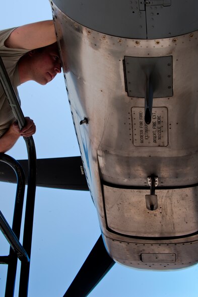 U.S. Air Force Staff Sgt. Douglas Wells, 317th Aircraft Maintenance Squadron, performs engine repairs prior to the aircraft taking part in the Mobility Forces Exercise at Nellis Air Force Base, Nev. May 23, 2012. The mass air mobility exercise, in which nearly 70 aircraft primarily consisting of C-17 Globemaster III and C-130 aircraft, practiced a "forced entry" operation. In the scenario, U.S. forces entered a simulated defended enemy country, defeated defending air defense forces and put troops on the ground. (U.S. Air Force photo by Airman 1st Class Damon Kasberg /Released)