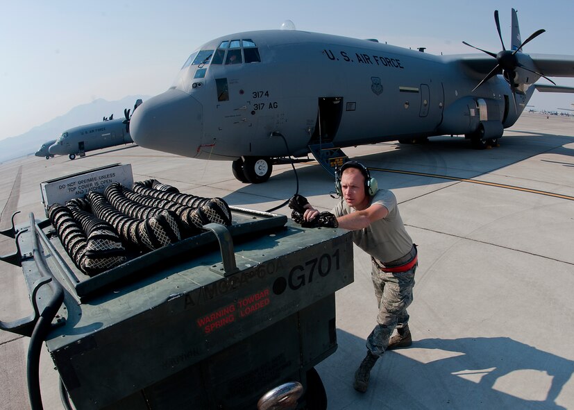U.S. Air Force Staff Sgt. Terry Wall, 317th Aircraft Maintenance Squadron, puts the external power on a C-130J May 23, 2012, prior to the aircraft taking part in the Mobility Forces Exercise at Nellis Air Force Base, Nev. The Mobility Forces Exercise included units from multiple services around the world, synchronized to arrive on the Nevada range in an orchestrated, combined force. The exercise combined airborne drops and landings on an unimproved landing strip, delivering approximately 100 paratroops and supporting equipment. (U.S. Air Force photo by Airman 1st Class Damon Kasberg /Released)