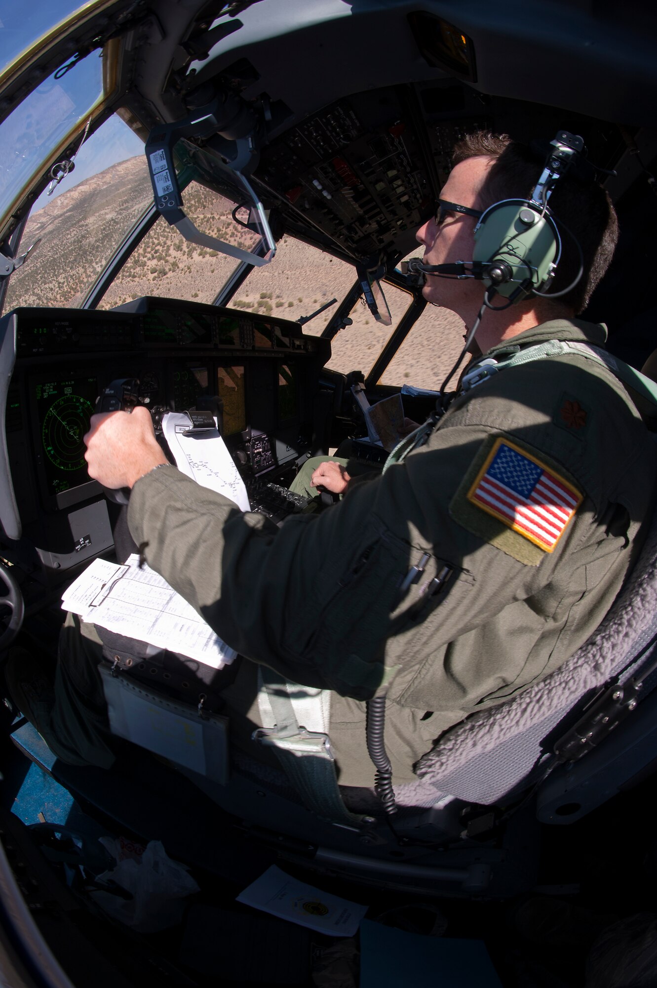U.S. Air Force Maj. Justin Diehl, 317th Airlift Group, flies a C-130 to Nellis Air Force Base, Nev. to support the U.S. Air Force Weapons School’s Mobility Forces Exercise May 21, 2012. The Mobility Forces Exercise included units from multiple services around the world, synchronized to arrive on the Nevada range in an orchestrated, combined force. The exercise combined airborne drops and landings on an unimproved landing strip, delivering approximately 100 paratroops and supporting equipment. (U.S. Air Force photo by Airman 1st Class Damon Kasberg /Released)