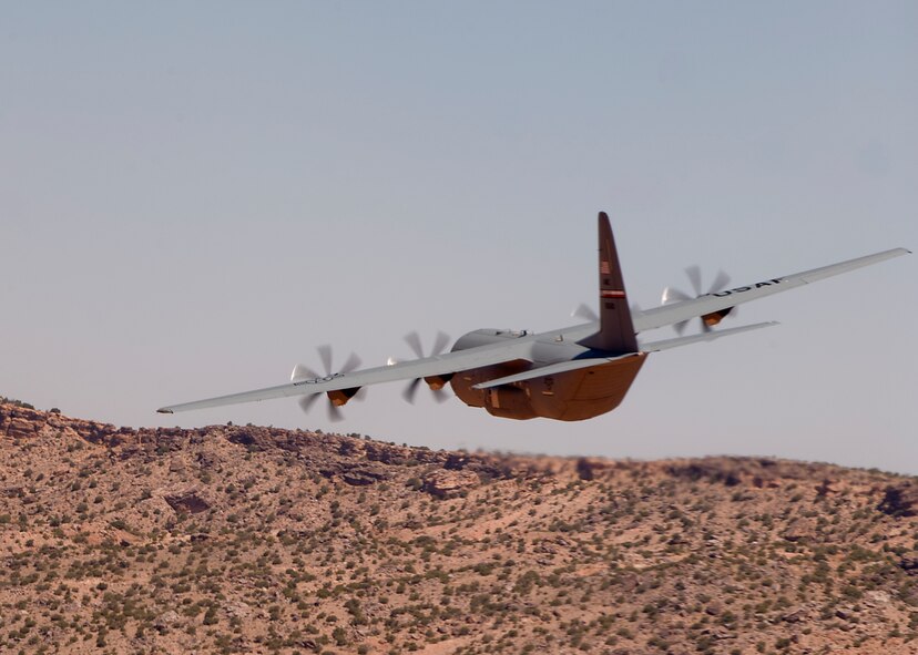 A C-130J from the 317th Airlift Group flies low-level maneuvers as they head toward Nellis Air Force Base, Nev. May 21, 2012, to support the U.S. Air Force Weapons School’s Mobility Forces Exercise. The Mobility Forces Exercise included units from multiple services around the world, synchronized to arrive on the Nevada range in an orchestrated, combined force. The exercise combined airborne drops and landings on an unimproved landing strip, delivering approximately 100 paratroops and supporting equipment. (U.S. Air Force photo by Airman 1st Class Damon Kasberg /Released)