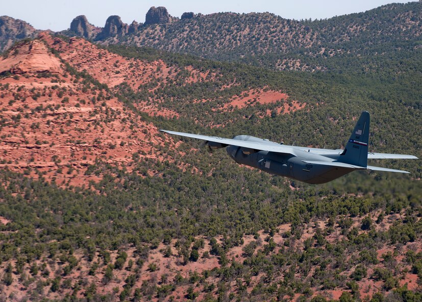 A C-130J from the 317th Airlift Group flies low-level maneuvers as they head toward Nellis Air Force Base, Nev. May 21, 2012, to support the U.S. Air Force Weapons School’s Mobility Forces Exercise. The exercise is part of a six-month Weapons Instructor Course conducted by the school. After graduation, Air Force Weapons School students become Weapons Officers, serving as expert advisors to military leaders on the use of Air Force and sister service's capabilities in concert. (U.S. Air Force photo by Airman 1st Class Damon Kasberg /Released)