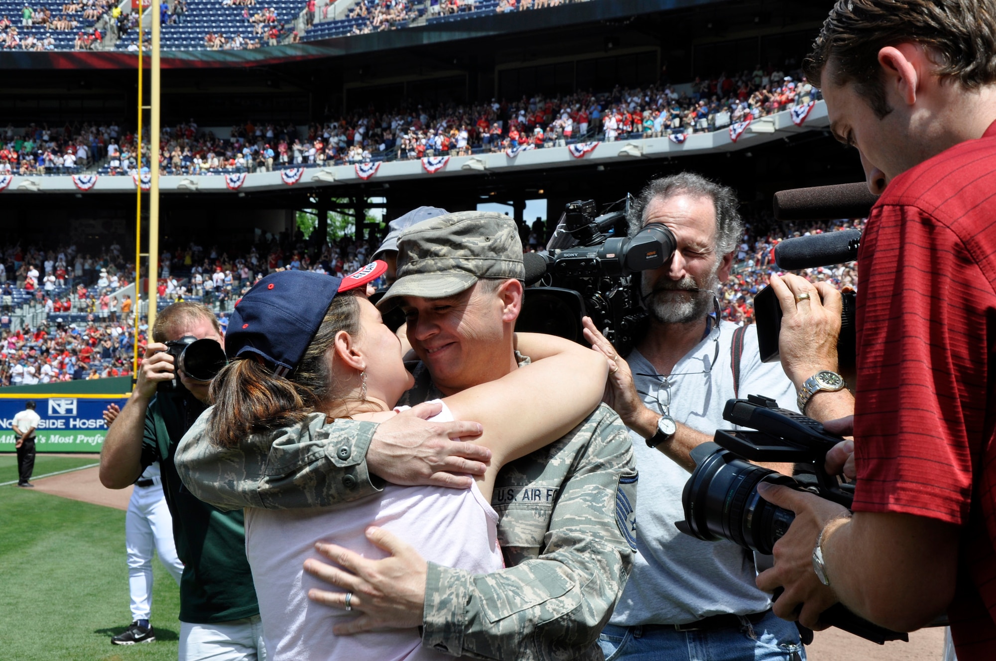 Master Sgt. David Sims embraces his wife, Robin, after surprising his family at the Atlanta Braves' Memorial Day game May 28, 2012, in Atlanta. Sims returned from a six-month deployment from Kabul, Afghanistan, May 27. Sims is assigned to Headquarters Air Force Reserve Command's Communications Directorate at Robins Air Force Base, Ga. (Defense Department photo/Jessica Blanton)
