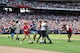Master Sgt. David Sims and his family embrace during a surprise homecoming May 28, 2012, at Turner Field in Atlanta. Sims’ family attended the Atlanta Braves game and was called onto the field at the top of the fifth inning for a special video tribute from Sims, who they thought was still in Afghanistan. Sims is assigned to Headquarters Air Force Reserve Command's Communications Directorate at Robins Air Force Base, Ga. (Defense Department/Photo by Jessica Blanton)