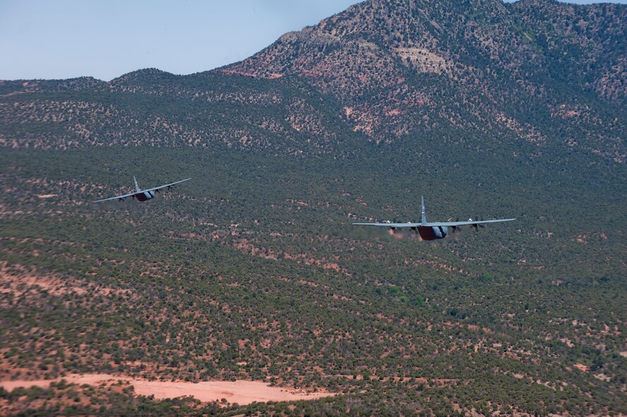 C-130Js from the 317th Airlift Group fly low-level maneuvers as they head toward Nellis Air Force Base, Nev. to support the U.S. Air Force Weapons School’s Mobility Forces Exercise May 21, 2012. The mass air mobility exercise, in which nearly 70 aircraft primarily consisting of C-17 Globemaster III and C-130 aircraft, practiced a "forced entry" operation. In the scenario, U.S. forces entered a simulated defended enemy country, defeated defending air defense forces and put troops on the ground. (U.S. Air Force photo by Airman 1st Class Damon Kasberg /Released)