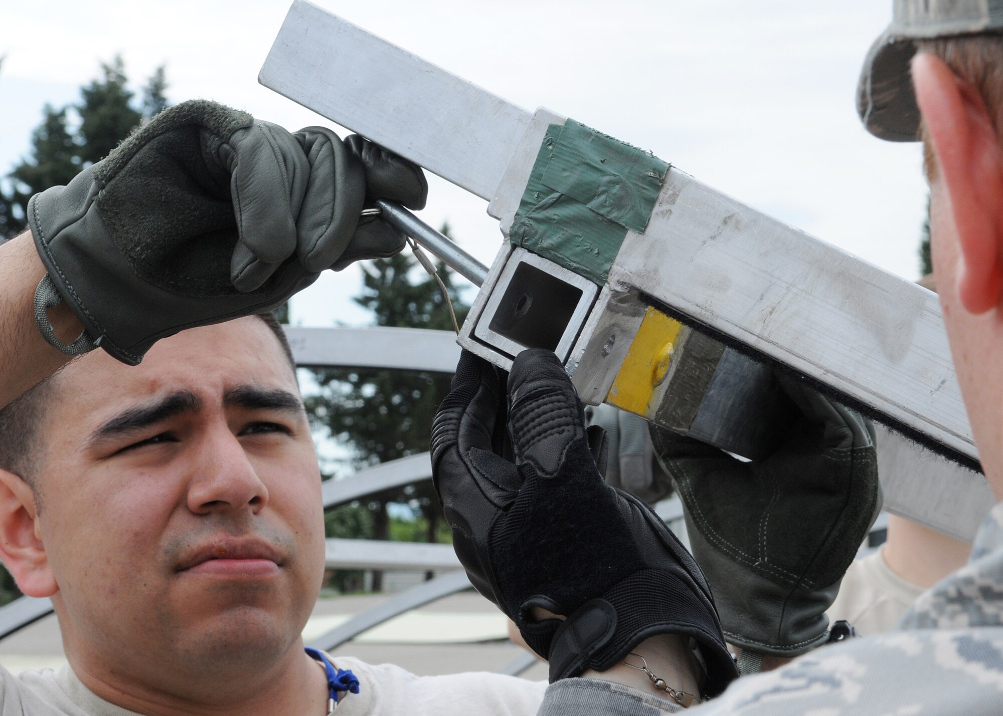 U.S. Air Force Staff Sgt. Javier Amaya, a Boynton Beach, Fla., native from the 48th Medical Operations Squadron, RAF Lakenheath, England, inserts a pin to secure an arch pole of an Alaskan tent during the Expeditionary Medical Support course here, May 30, 2012. During the course, instructors from Joint Base San Antonio, Texas, taught more than 50 U.S. military members how to set up and operate a medical facility in a deployed environment. More than 500 military members from nine nations are participating in SR12, an annual U.S. Joint Chiefs of Staff sponsored exercise, May 28 - June 8. The goals of the exercise are to strengthen interoperability, facilitate training in crisis response and disaster management, and validate the readiness of deployable military medical and humanitarian assistance teams. The exercise, in the spirit of partnership for peace, directly supports U.S. European Command's theater cooperation efforts and strategy for active security with European countries.