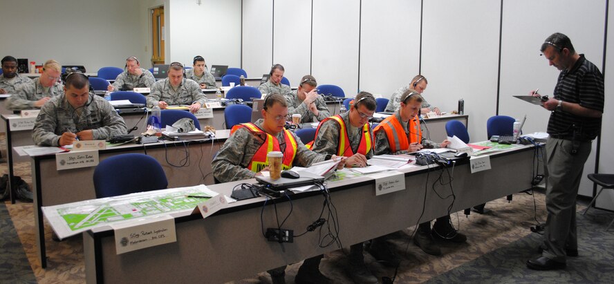 Members of the Fire Officer II class stay engaged in a scenario as Simmons, far right, evaluates the three command positions. The class ran from May 9 to 24 and was made up of Airmen throughout Air Force Global Strike Command. (U.S. Air Force photo/Airman 1st Class Cortney Paxton)