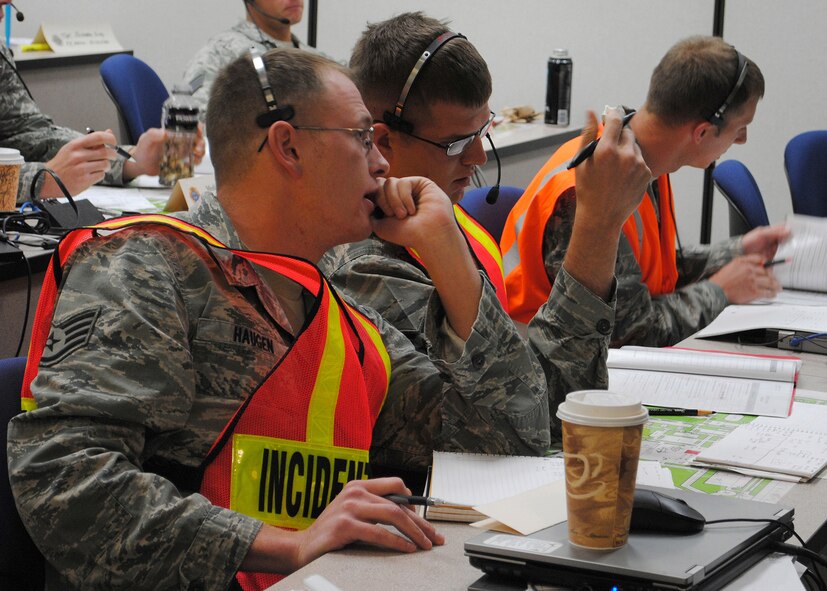 Haugen discusses his next step in a scenario with Staff Sgt. Michael Braach, 28th CES firefighter, Ellsworth AFB, S.D. Staff Sgt. Matthew Wright, 28th CES firefighter, Ellsworth AFB, S.D., looks over his paperwork in the background. (U.S. Air Force photo/Airman 1st Class Cortney Paxton)