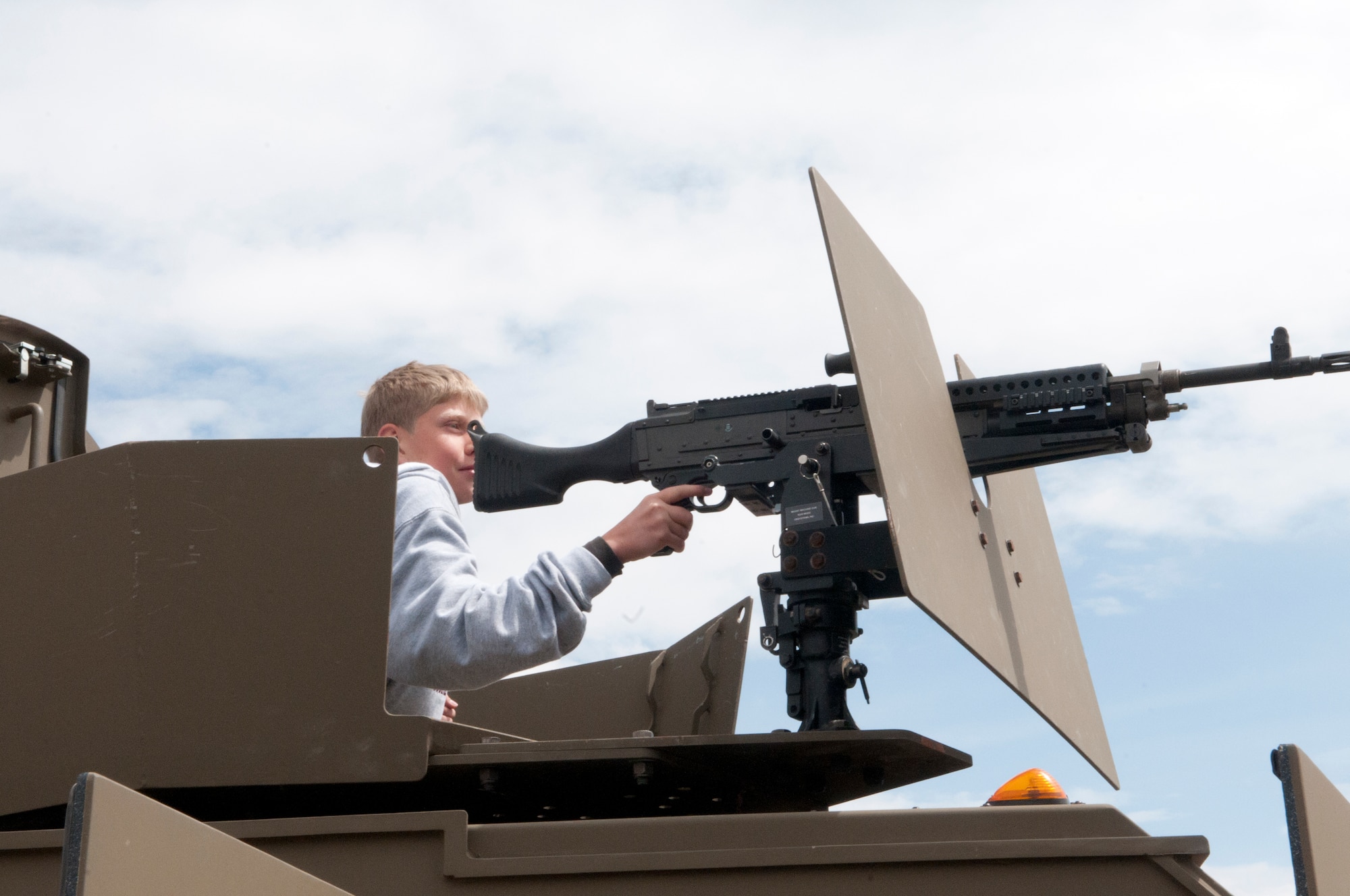 Nathaniel House, a Cheyenne, Wyo., resident, sits in the turret of a Humvee during the Armed Forces Day celebration at the Frontier Mall in Cheyenne, Wyo., May 19. (U.S. Air Force photo by Airman Jason Wiese)