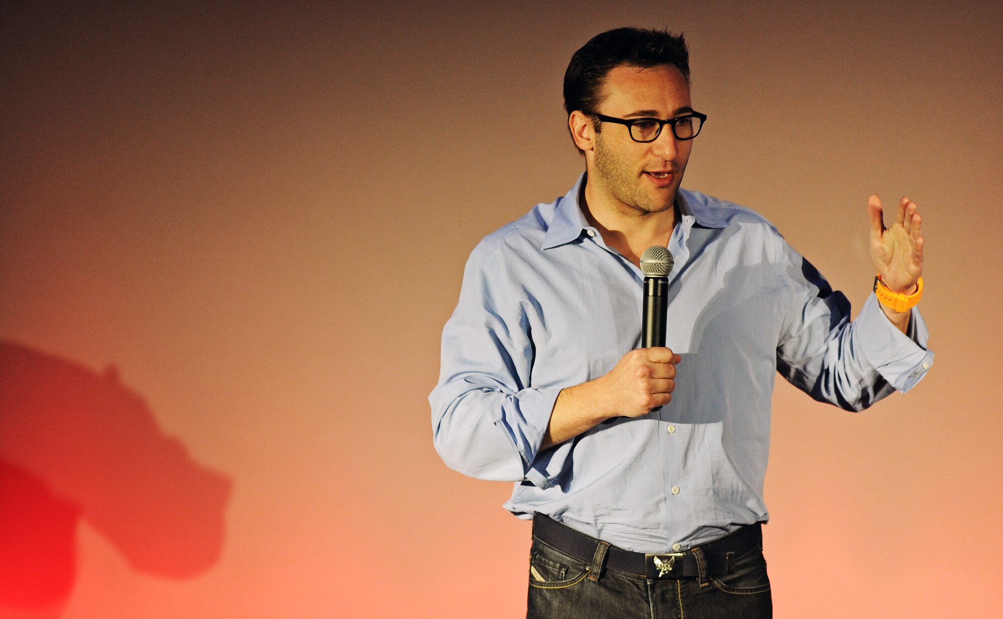 Simon Sinek, event emcee and public speaker gives the audience an introduction to the TEDx event at Scott Air Force Base, Ill. May 30. With a bold goal to help build a world in which the vast majority of people go home everyday feeling fulfilled by their work, Sinek is leading a movement to inspire people to do the things that inspire them. (U.S. Air Force photo/ Staff Sgt. Ryan Crane)