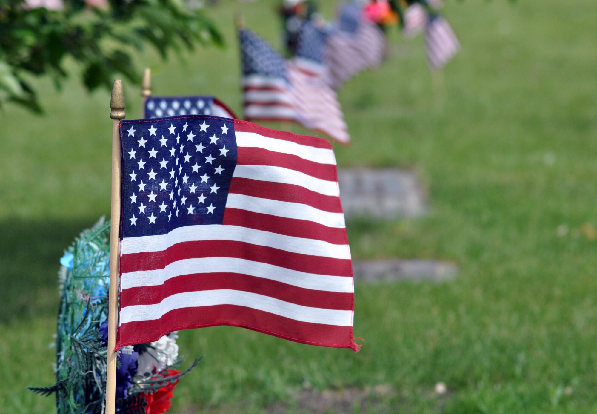 About 225 volunteers from Grand Forks Air Force Base, N.D., helped honor fallen veterans by placing U.S. flags on graves at Sunset Memorial Gardens, pictured here, and Memorial Park Cemetery, both in nearby Grand Forks city, on May 25, 2012, in advance of Memorial Day. (U.S. Air Force photo/Tim Flack)