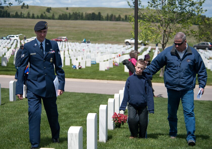 Senior Airmen Andrew Meneghini, 28th Security Forces Squadron defender, assists cemetery visitors locate specific gravesites at the Black Hills National Cemetery, S.D., May 28, 2012. The BHNC’s theme this year was “Never Forget, Ever Honor.” Approximately 23,769 people visited the cemetery throughout Memorial Day weekend. (U.S. Air Force photo by Airman 1st Class Alystria Maurer/Released)