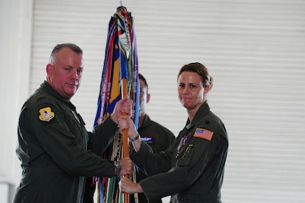 Colonel Erik Hansen, 437th Airlift Wing commander, receives the squadron guidon on from Lt. Col. Rebecca Sonkiss, 15th Airlift Squadron outgoing commander, during the 15th AS change of command ceremony at JB Charleston - Air Base, S.C, May 24, 2012.  The handing over of the guidon symbolizes the changing of a command.  Lt. Col David Owens assumed command of the 15th AS.  (U.S. Air Force photo/ Staff Sgt. Nicole Mickle) 