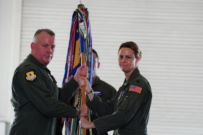 Colonel Erik Hansen, 437th Airlift Wing commander, receives the squadron guidon on from Lt. Col. Rebecca Sonkiss, 15th Airlift Squadron outgoing commander, during the 15th AS change of command ceremony at JB Charleston - Air Base, S.C, May 24, 2012.  The handing over of the guidon symbolizes the changing of a command.  Lt. Col David Owens assumed command of the 15th AS.  (U.S. Air Force photo/ Staff Sgt. Nicole Mickle) 