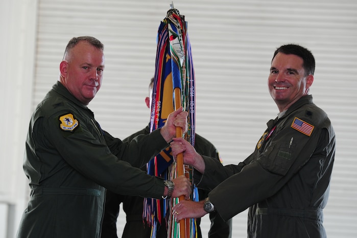 Colonel Erik Hansen, 437th Airlift Wing commander, hands the squadron guidon to Lt. Col. David Owens, 15th Airlift Squadron incoming commander, during the 15th AS change of command ceremony at JB Charleston - Air Base, S.C, May 24, 2012. The handing over of the guidon symbolizes the changing of a command.  (U.S. Air Force photo/ Staff Sgt. Nicole Mickle) 